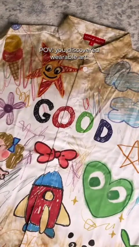 Hand-drawn doodle shirt and paint-splatter jeans up close